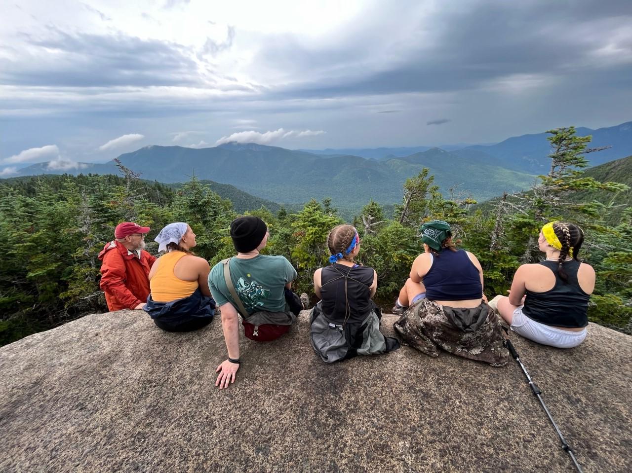 Students on Wilderness Trip, sitting on giant boulder